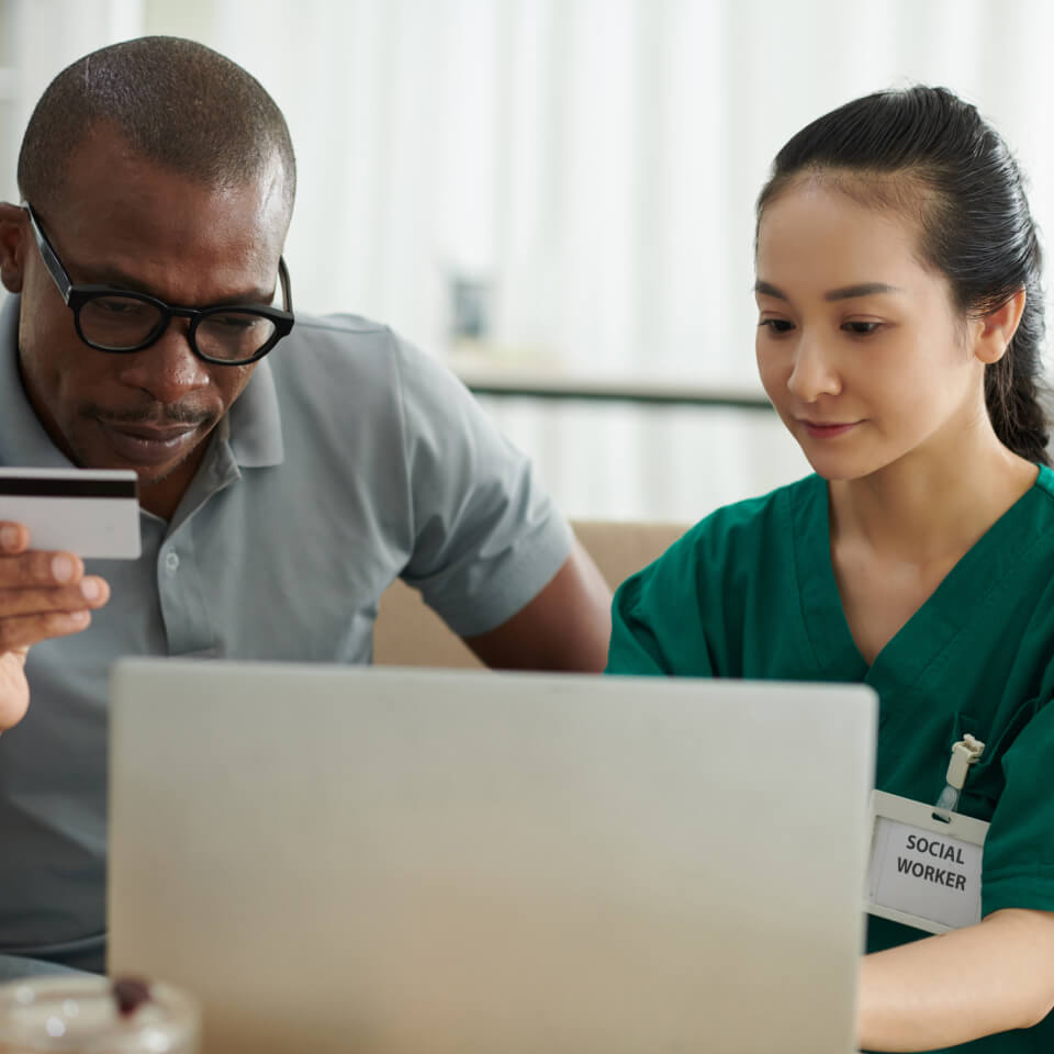 Healthcare staff reviewing financial information on a laptop